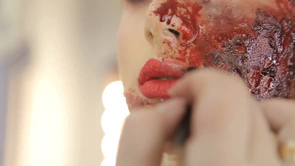 Make-up artist make the girl halloween make up in studio. alt