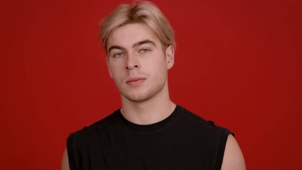 Studio Portrait of Handsome Blonde Guy Looking Seriously at Camera alt