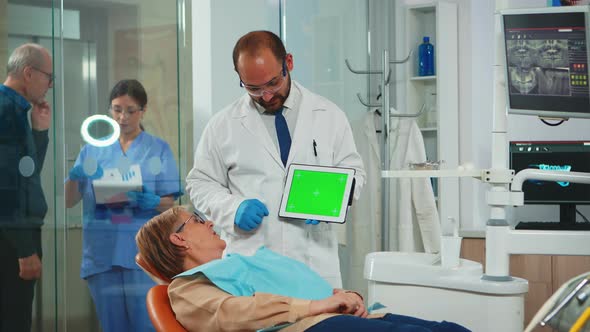 Dentist Pointing at Green Screen Display alt
