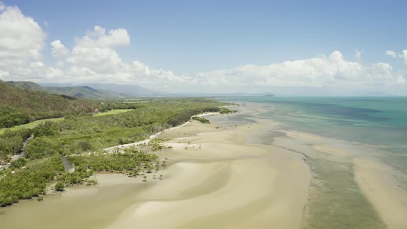 Aerial, Low Tide And Huge Sand Ocean Bed And Mangroves Growing In Queensland Australia