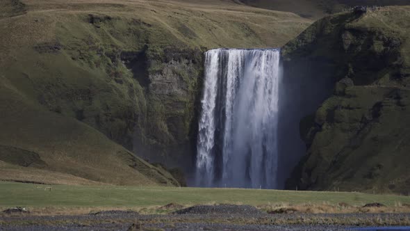 Skogafoss Waterfall with Tourists on Top Viewpoint Iceland
