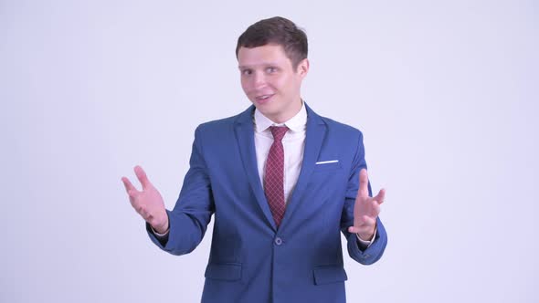 Happy Young Handsome Businessman Looking Surprised alt