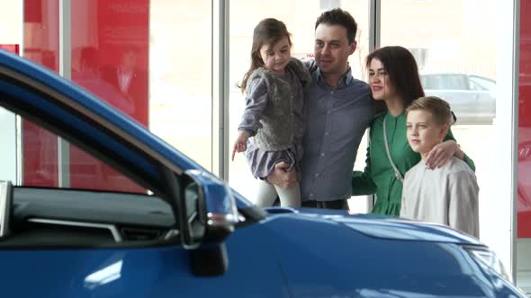 Mother Father and Child Buying Car at Dealership a New Family Auto alt