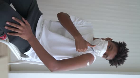 Vertical Video of African Teenager Showing COVID19 Vaccine Bandage Merrily alt