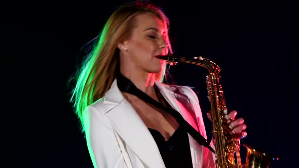 Young Sexy, Blonde Woman Dj in White Jacket Playing Music Using Saxophone on Black, Cam Moves Upward alt