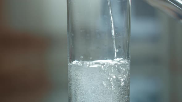 Sparkling Water Is Poured Into a Glass From a Decanter Close Up, Moving Camera alt