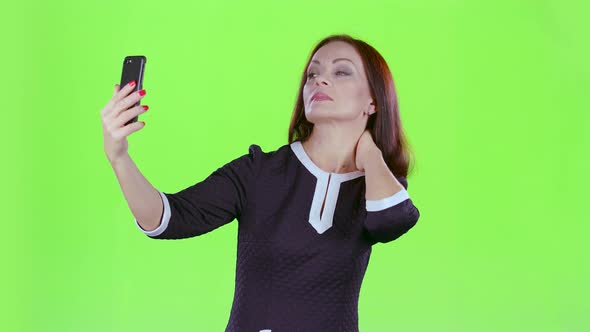 Woman Makes Selfie on Her Phone, Green Screen alt