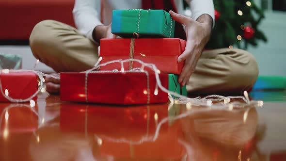 Young Asian man making a gift box in the living room at home.