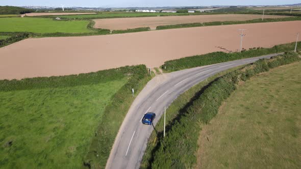 The car is moving on a country road. Outside the city through the fields.