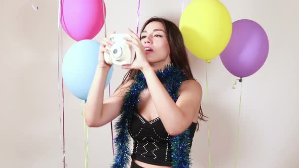 Sexy brunette woman taking polaroid photos alt