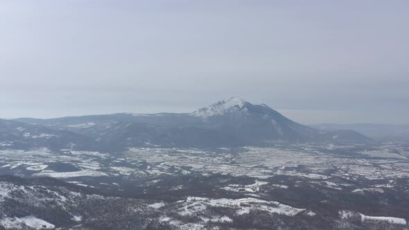 Winter scene with mountain Rtanj in background 4K aerial footage alt