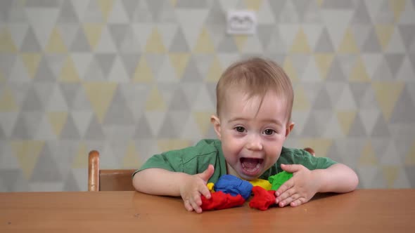 a Little One-year-old Girl Playing with Plasticine