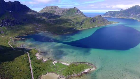 Aerial shot of scenic route around fjord on Lofoten islands in Norway alt