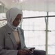 AfricanAmerican Business Woman in Hijab Texts on Phone - VideoHive Item for Sale