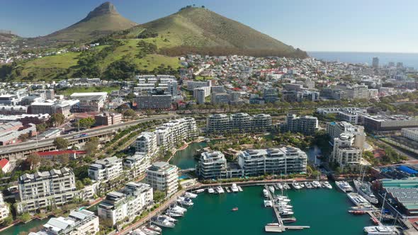 Drone flying toward the marina island with Lions head mountain in the background