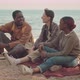 Multiethnic Friends Sitting on Sand Beach - VideoHive Item for Sale
