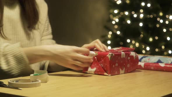 Closeup of the Hands Packing Gift