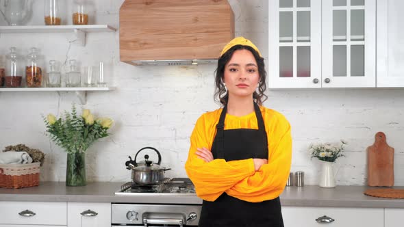 Portrait Serious Housewife Crossing Hands Looking Camera in Home Modern Kitchen alt