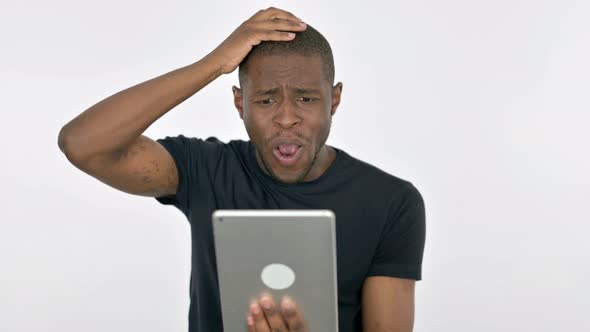 Young African Man Reacting to Loss on Tablet on White Background alt