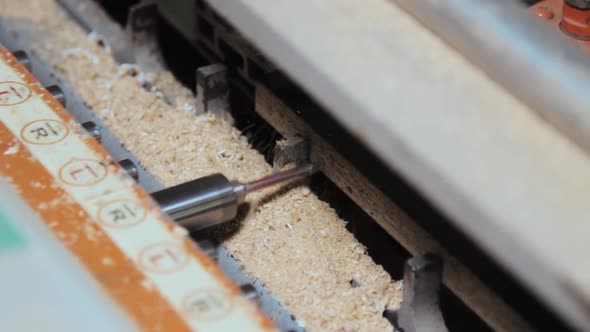 Process of drilling holes in a furniture board