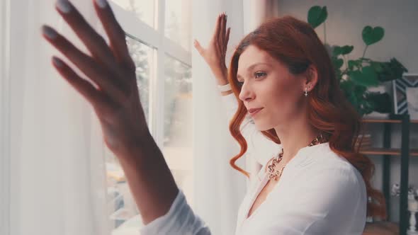 Happy Optimistic Young Woman Opening Curtain Lace Looking Through Window alt