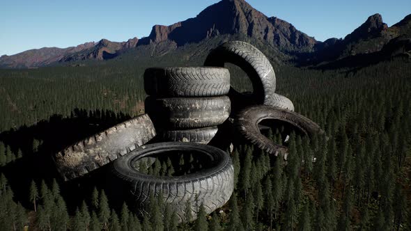 Concept of Environmental Pollution with Big Old Tires in Mountain Forest alt
