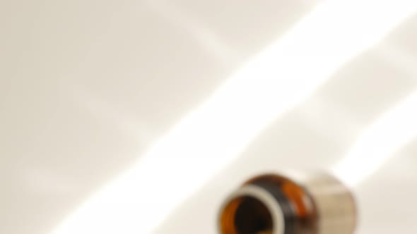 Pills spilled from plastic container close-up tilting 4K 2160p 30fps UltraHD footage - Slow tilt  ta alt