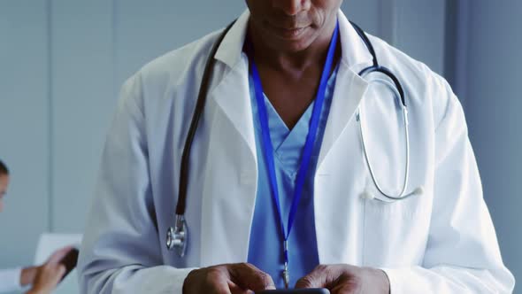 Close-up of African American male doctor using mobile phone in hospital 4k alt