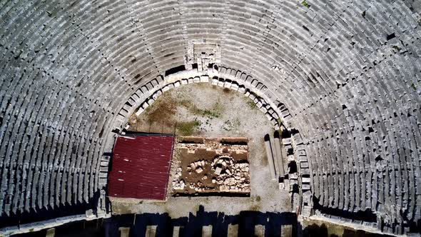 High angle drone aerial view of ancient greek rock cut lykian empire amphitheatre and tombs in Myra alt