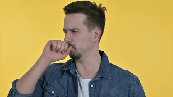 Portrait of Sick Young Man Coughing, Yellow Background alt
