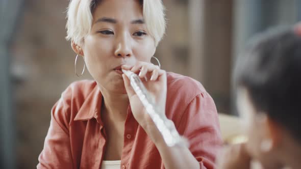 Asian Mother and Son Playing with Party Horns alt