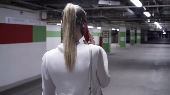 Walking Young Woman with Pony Tail White Shirt and Black Skirt in Garage
