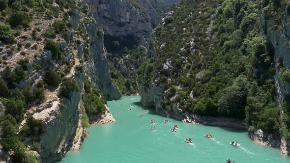 People Sailing on Pedal Boats at the Verdon Gorge Between Alps Mountains in Provence, France. Waters alt