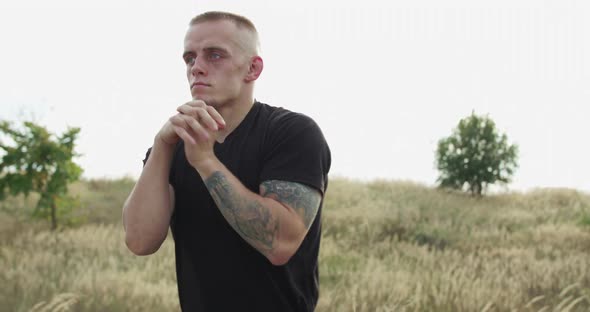 Serious Sportsman Stretching the Wrists at Nature alt