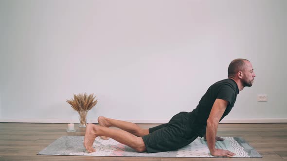 Caucasian Man Does Yoga Online Man on the Mat Makes the Dog Face Up Yoga for Beginners Gymnastics alt