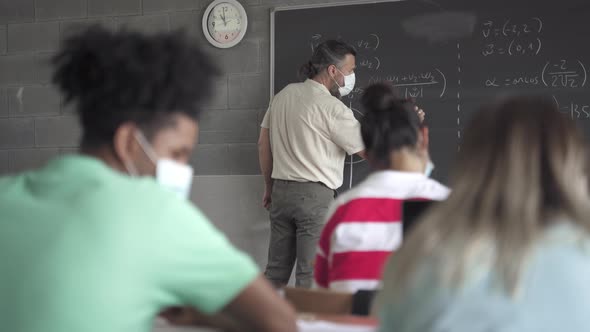 Teacher and Teenager Students with Face Mask Learning in the High School Lecture alt