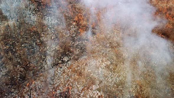 Drone aerial view of wildfire in the mountains.