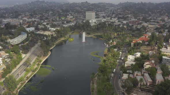AERIAL: Over Echo Park in Los Angeles, California with Palm Trees, Cloudy  alt