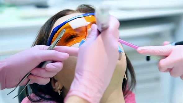 Patient With Protective Glasses For Teeth Whitening Procedure