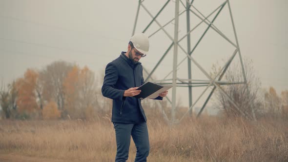 High Voltage Engineer Inspector Power Line Worker.Electrical Engineer In Helmet Power Lines. alt