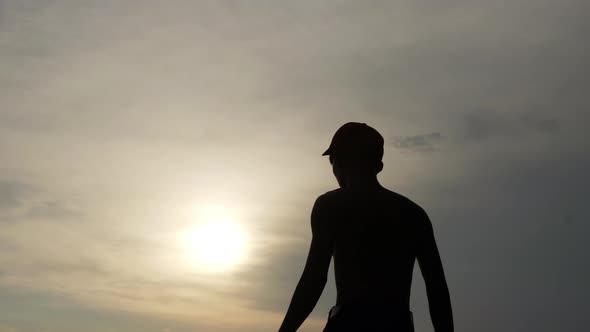 Silhouette of man holding sword alt
