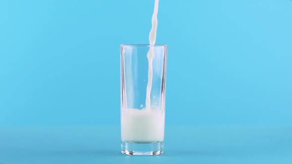Milk Cold Beverage Drink Pooring Into Low Glass Blue  alt