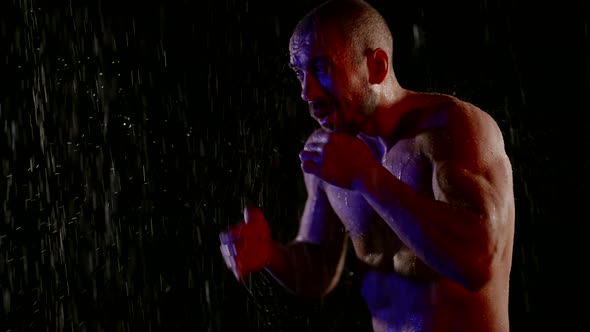 Boxer is Attacking Imaginary Enemy Fighting in Rain in Dark Night Epic and Dramatic alt