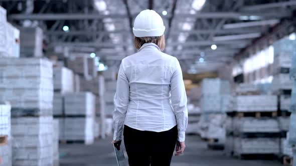 Follow Footage of Employees Famale Warehouse Worker Engineer in Hard Hat Working alt