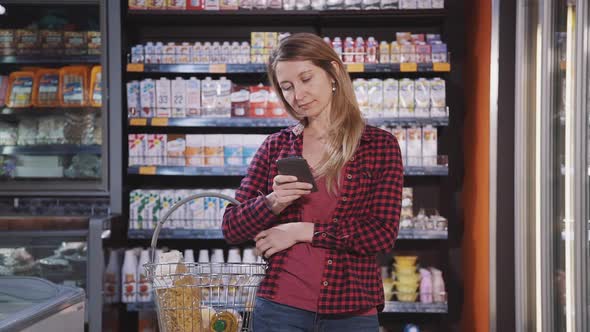 Mature Woman Buying Quality Products in the Hypermarket alt