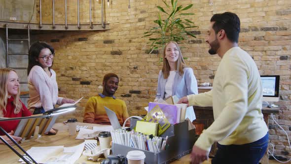 Cheerful Multiethnic Colleagues Cooperating in Designer Office