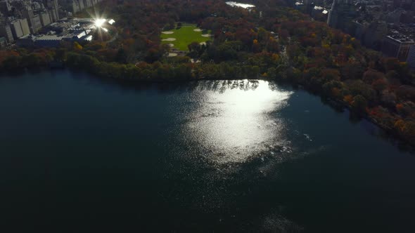 Aerial View of Water Reservoir and Autumn Colour Trees in Central Park Surrounded By Town alt