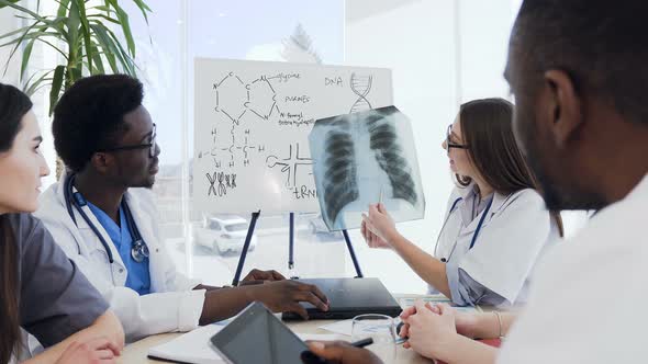 Professional Doctors Discussing an X-ray alt