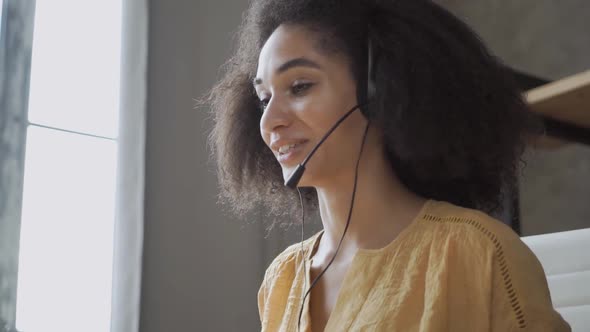 Smiling African American Woman with Headset Using Laptop, Talking, Working Customer Support Service alt
