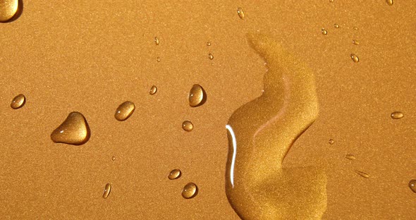 Abstract water drops on gold bronze background, macro